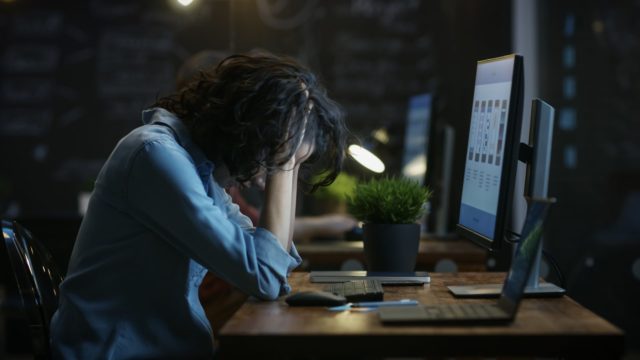woman at computer stressed about social media disaster