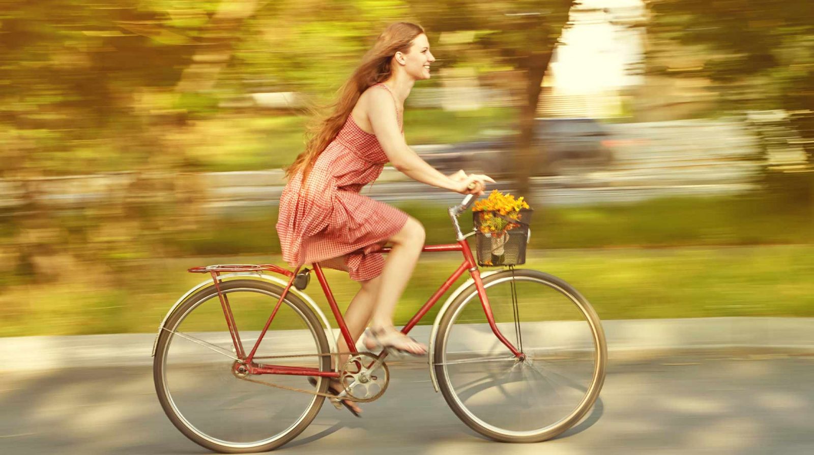 woman cycling in summer dress