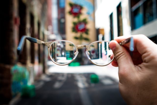view of a street through a pair of glasses