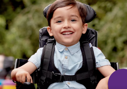 boy in wheelchair smiling