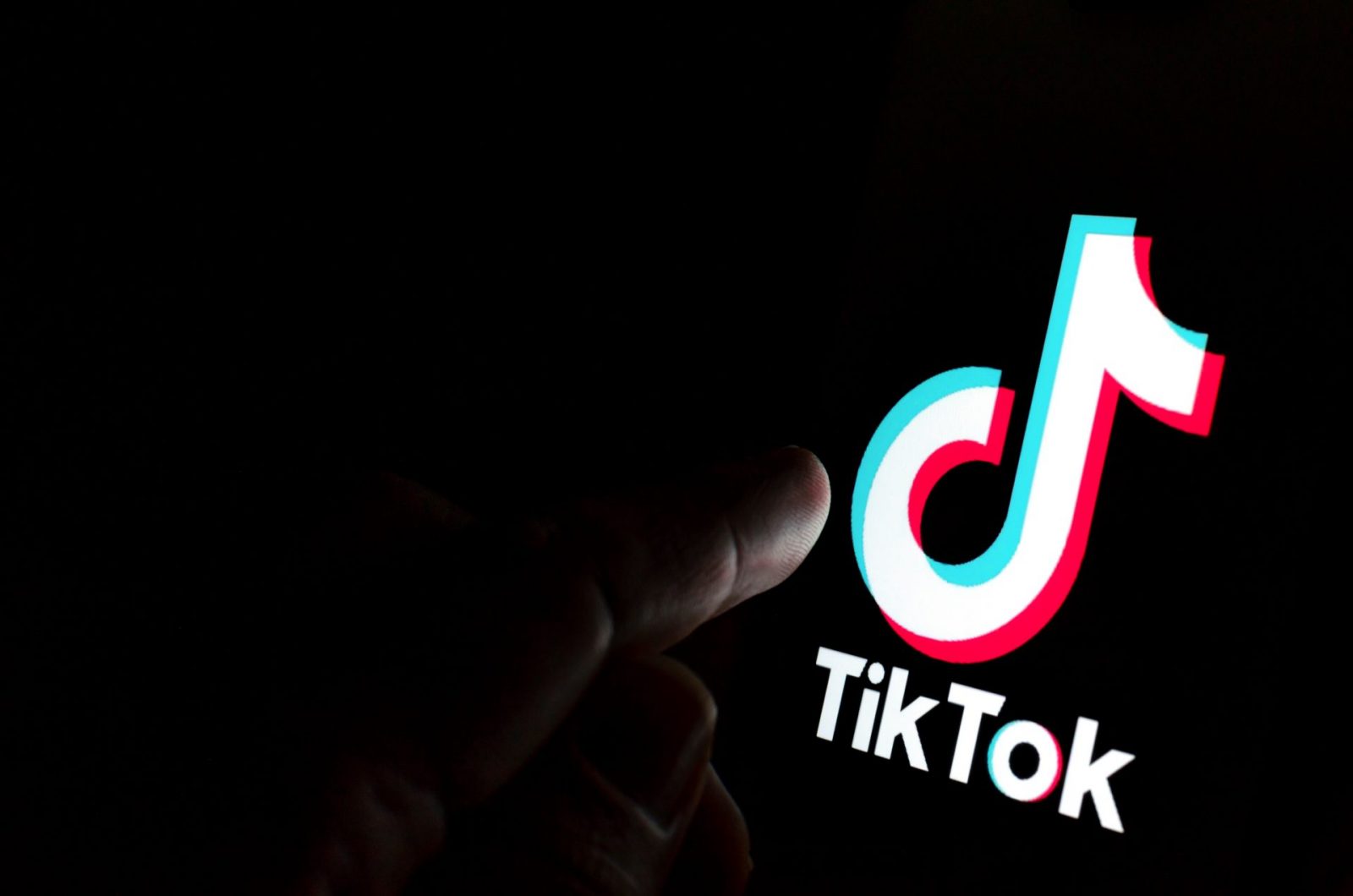 finger pointing to TikTok logo