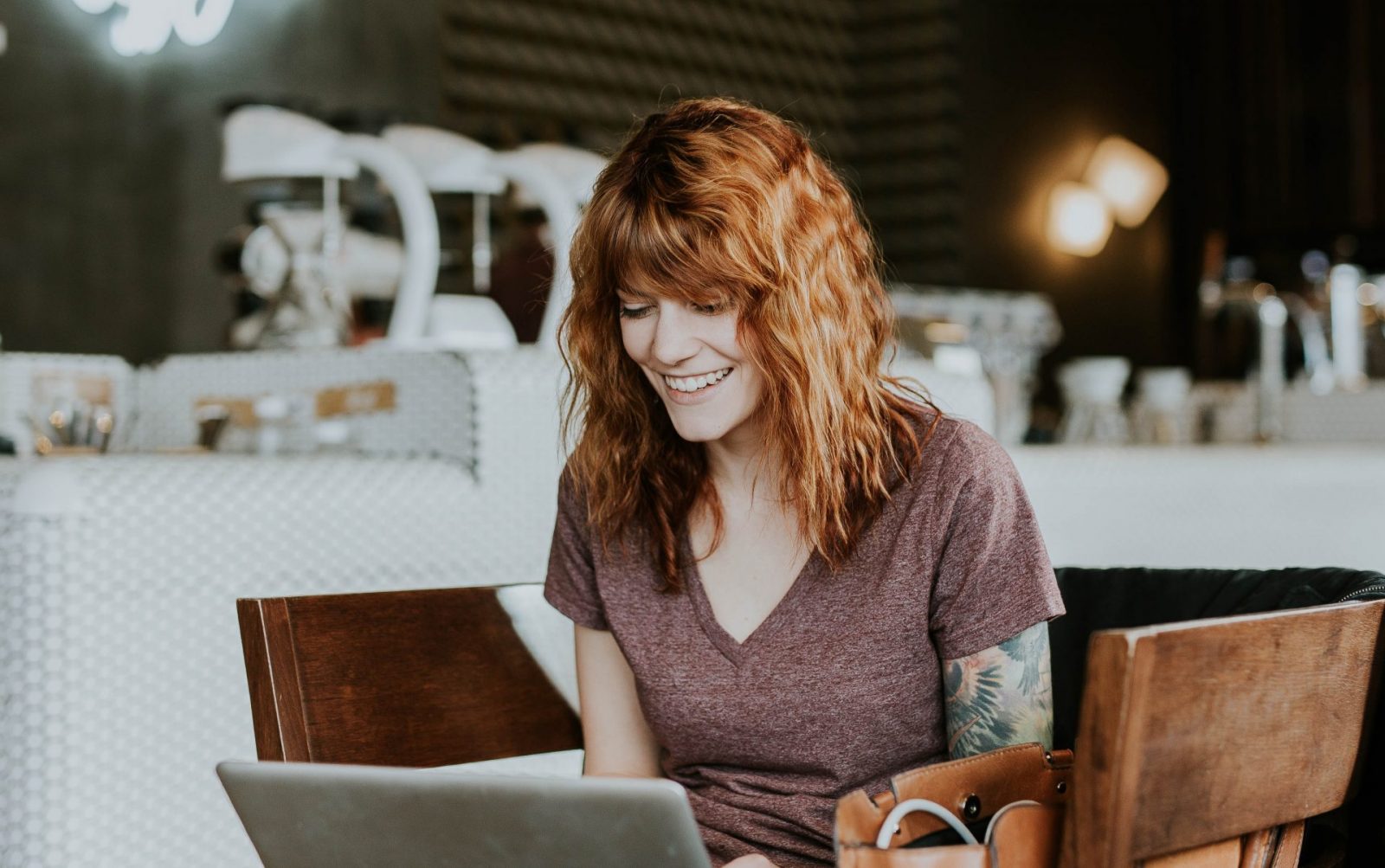 red haired woman on a laptop