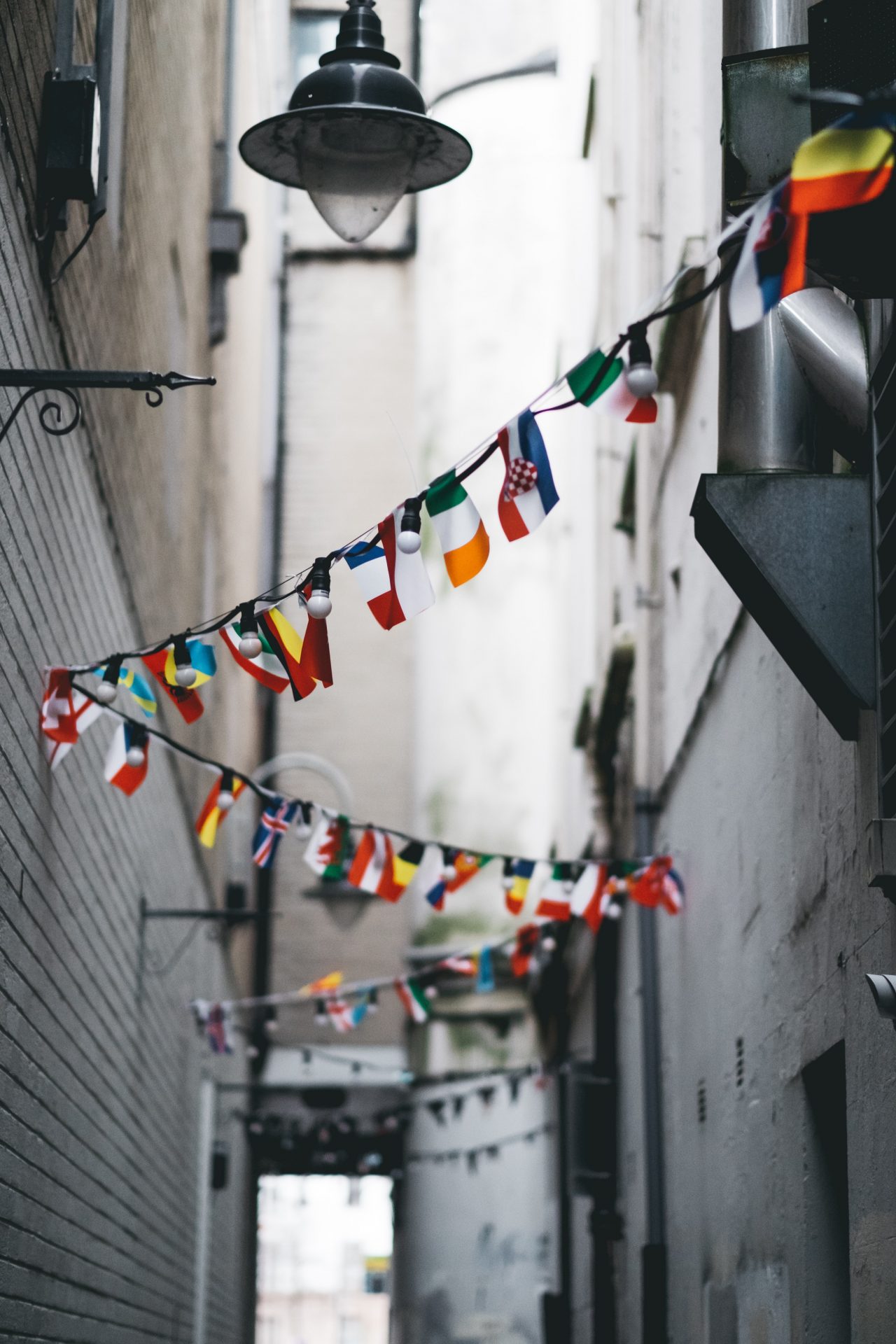international country flags hanging down an alley