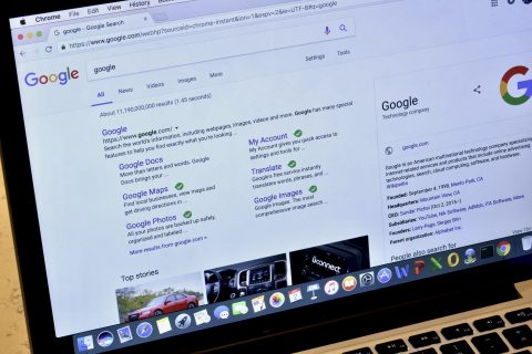 google search results for 'google' on laptop screen