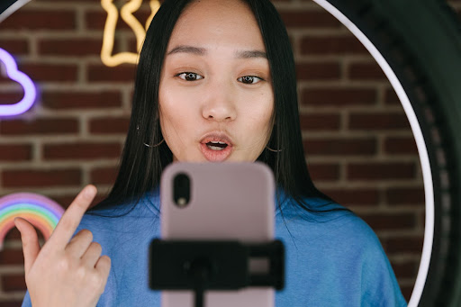 woman vlogging into a phone